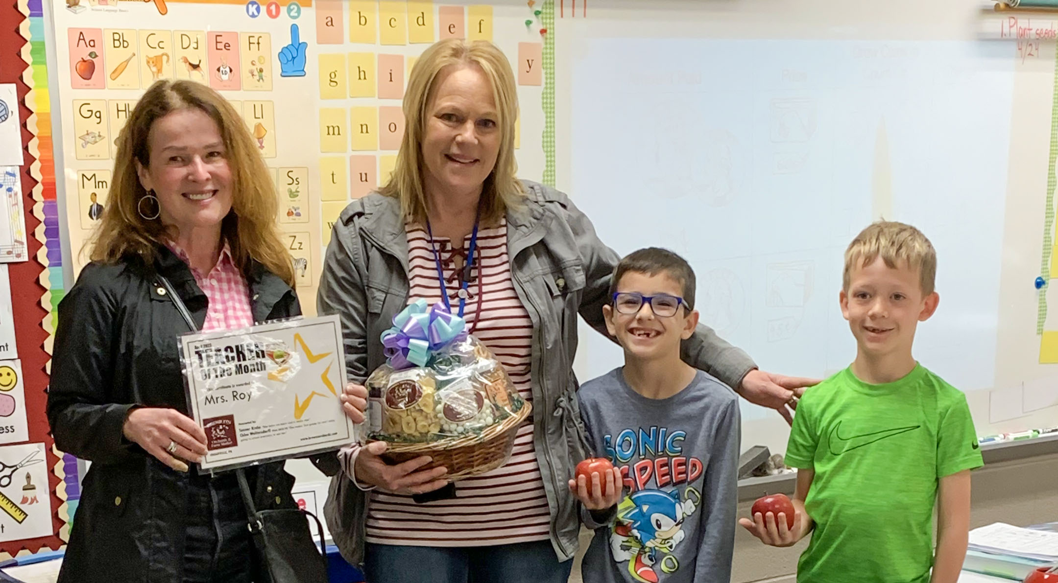 Mary Brown and Melinda Roy with two students